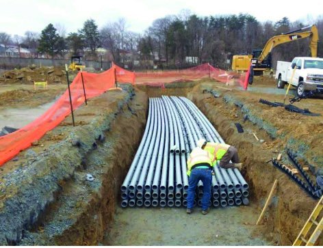 ConnXX crew installing a multi-conduit duct bank in an open trench